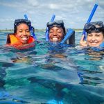 three women inside the water with snorkeling gear during a luxury private yacht rental playa del carmen riviera maya mexico