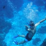 man snorkeling a reef during a private tour in playa del carmen, riviera maya, mexico