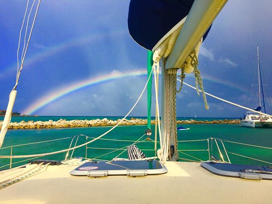 rainbow behind a catamaran charter in puerto aventuras, riviera maya, mexico