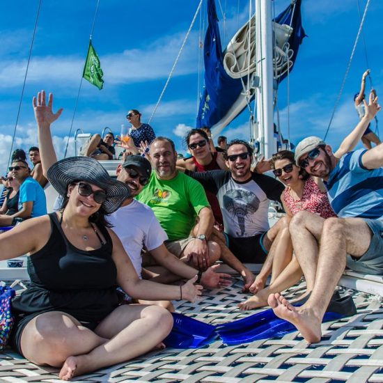 happy group of people onboard the catamaya catamaran in playa del carmen, puerto aventuras, riviera maya, mexico