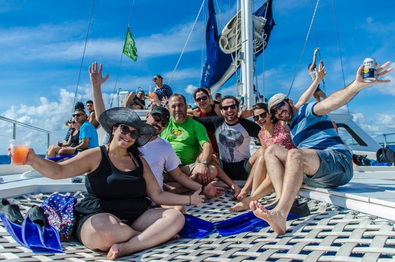 happy group of people onboard the catamaya catamaran in playa del carmen, puerto aventuras, riviera maya, mexico
