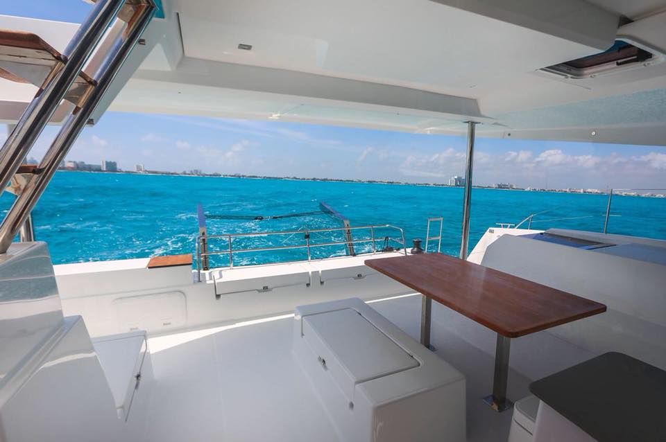 rear view of table and water onboard a catamaran rental in cancun and isla mujeres