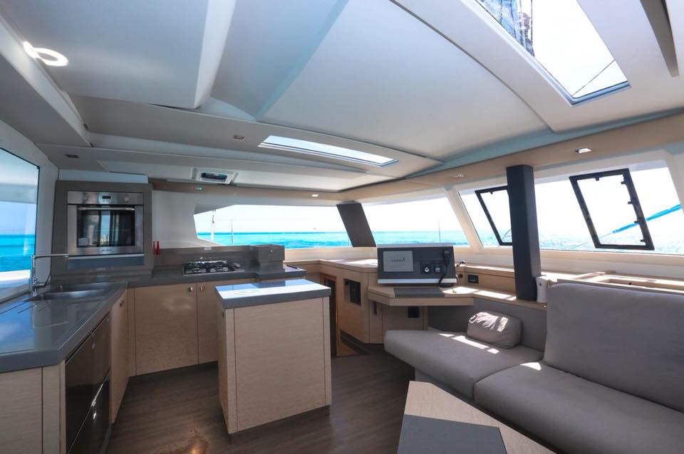 interior sofa, kitchen and radio from a private catamaran for rent in cancun and isla mujeres