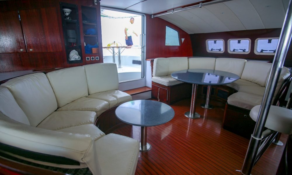 interior sofas and tables of a catamaran for rent in cancun, mexico