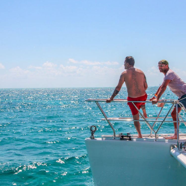 men on catamaran cancun isla mujeres riviera maya catamarans 1