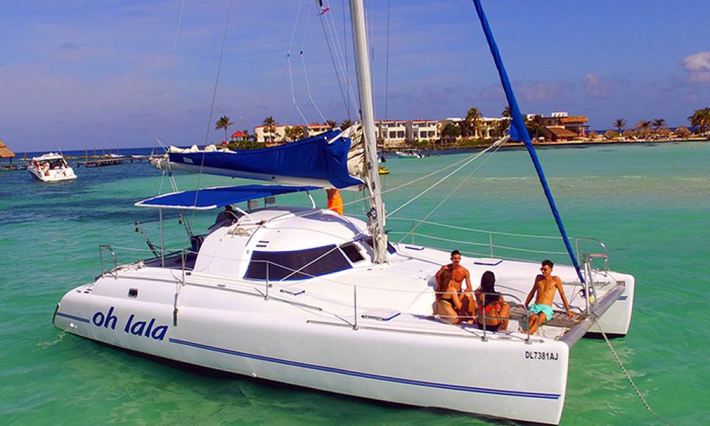 people onboard a catamaran charter in isla mujeres mexico