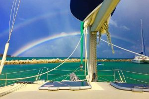 rainbow behind a catamaran charter in puerto aventuras, riviera maya, mexico