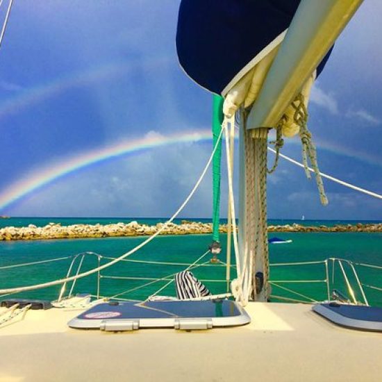 rainbow behind a catamaran charter in puerto aventuras, riviera maya, mexico