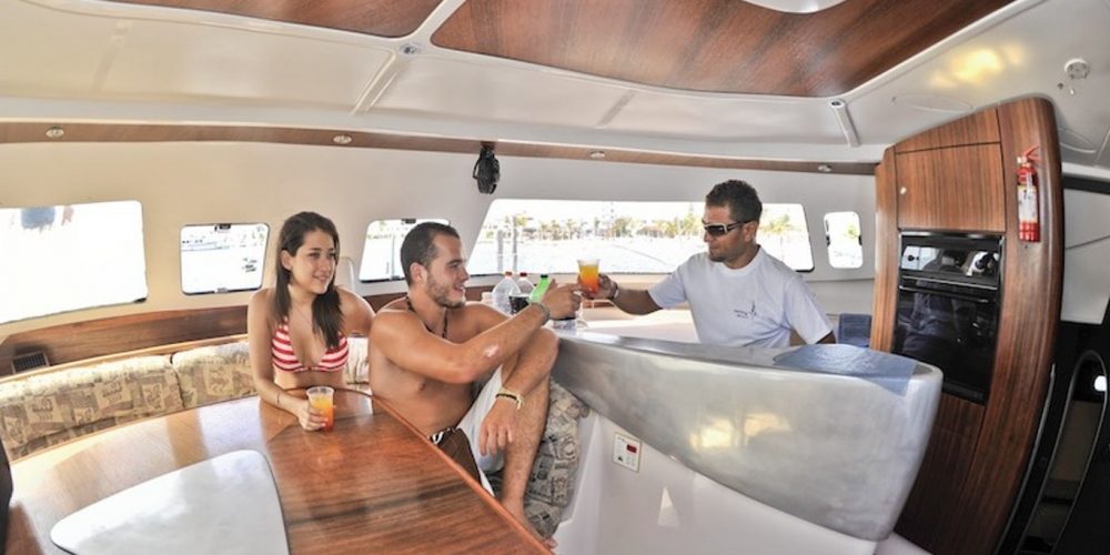 people inside a catamaran for rent in cozumel mexico